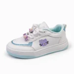 Side view of girls' white sneakers featuring purple cartoon embroidery and decorative lace beads.