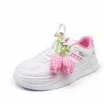 Side view of white and pink floral sneakers for girls in Bangladesh.