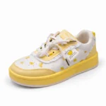 Side view of cute girls shoe showing thick yellow sole and ruffled details.
