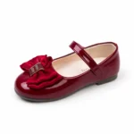 Side view of stylish wine red glossy flats for girls with strap