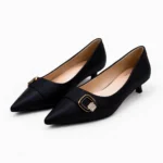 Pair of women's black low heel pumps with golden square buckle imported shoe.
