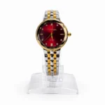 Women's luxury quartz watch with red dial, crystal markers, and silver-gold two-tone strap.