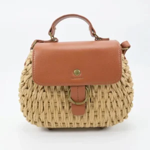 Front view of women's natural beige woven straw tote bag with ring decoration in Bangladesh