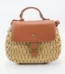 Front view of women's natural beige woven straw tote bag with ring decoration in Bangladesh