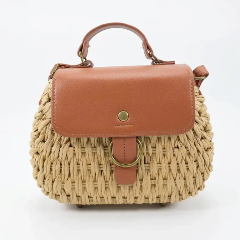 Front view of women's natural beige woven straw tote bag with ring decoration in Bangladesh